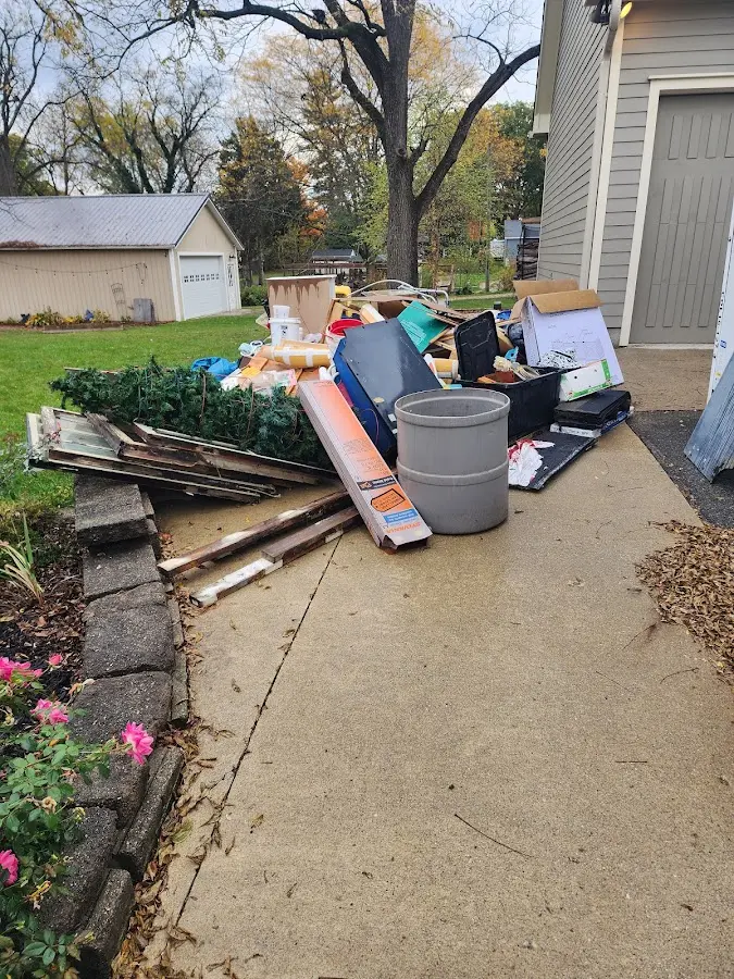 Dumpster being loaded with debris for Estate Cleanout Dumpster Rental in North Manchester